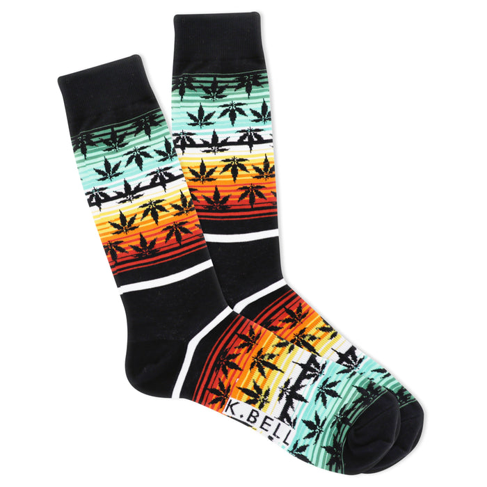 Pair of crew socks, black with horizontal stripes of orange, red, yellow, and teal, featuring a repeating pattern of dark-green marijuana leaf silhouettes. }}