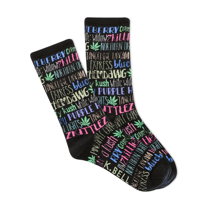 Pair of black crew socks. The socks feature a colorful pattern of cannabis strain names (e.g., 'Zkittles', 'Northern Lights') in pink, blue, and purple, with small marijuana leaf graphics. }}
