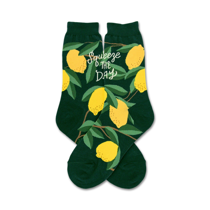 Pair of dark green crew socks with a pattern of yellow lemons and green leaves. The phrase 'Squeeze the Day' is printed on the socks. }}