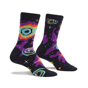 Crew socks in black with a purple, orange, and yellow nebula pattern and white stars.