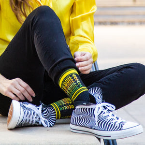 Close-up shot of a person wearing the Tequila socks with black and white zebra print shoes.  Focus on the socks and shoes.