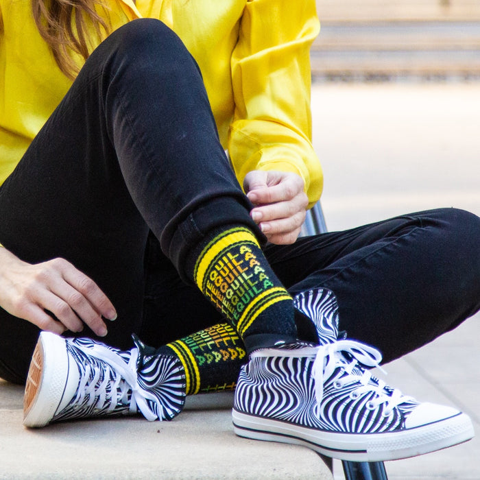 Close-up shot of a person wearing the Tequila socks with black and white zebra print shoes.  Focus on the socks and shoes.
