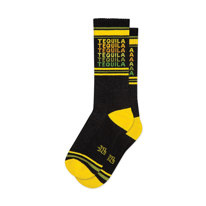 Crew socks in black with a repeating 'Tequila' pattern in yellow, orange, and green. Yellow and dark green stripes at the cuff.