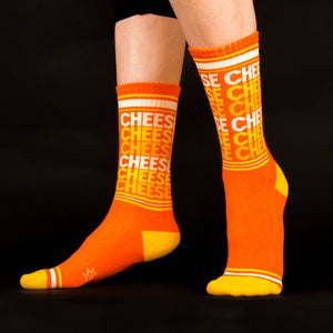 Lifestyle shot showing the socks on a person's legs against a black background.