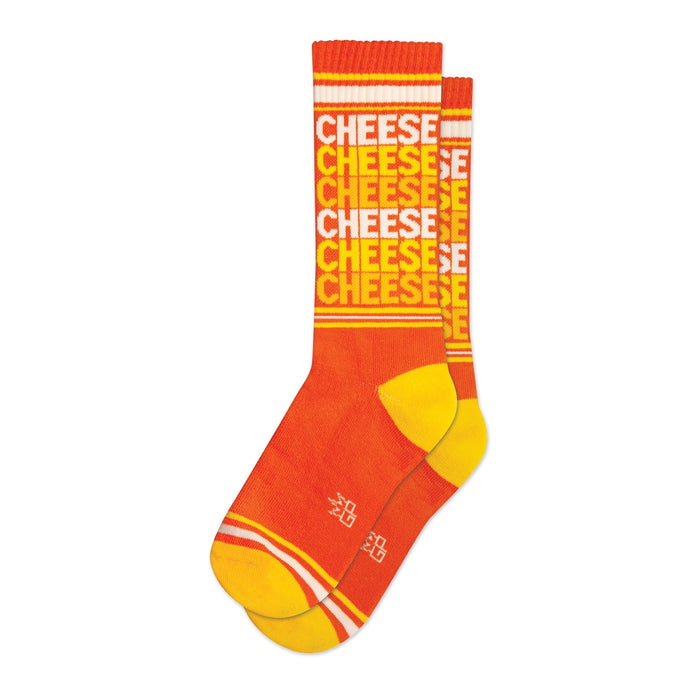 Pair of orange crew socks with a repeating 'CHEESE' pattern in a lighter orange and white. Yellow stripes are visible at the top and bottom cuffs.