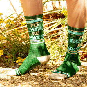 Lifestyle photo showing the socks on a person's feet in a garden setting.