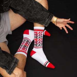 Lifestyle shot of a person wearing the 'Meat' socks.