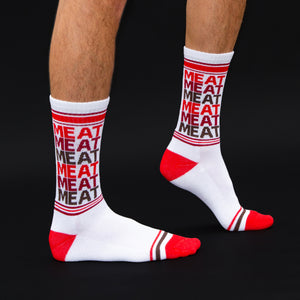 Flat lay of the 'Meat' socks on a dark surface.