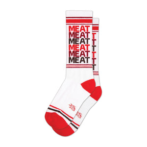 White crew socks with a repeating 'MEAT' pattern in red and brown. Red and brown stripes at the cuff and heel.