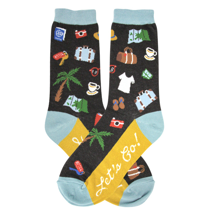 Crew socks with a dark background featuring colorful travel-themed illustrations like palm trees, suitcases, and cameras. Teal cuffs and yellow heel with 'Let's Go!' text. }}