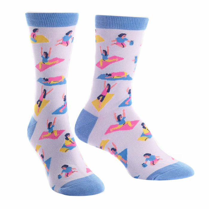 Pair of lavender crew socks with colorful yoga illustrations and light blue cuffs. Fun and quirky design for yoga lovers! }}
