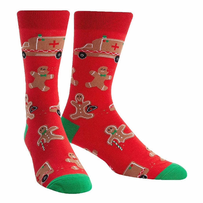 A pair of red crew socks with a fun Christmas design. The socks feature gingerbread men, ambulances, and candy canes. }}