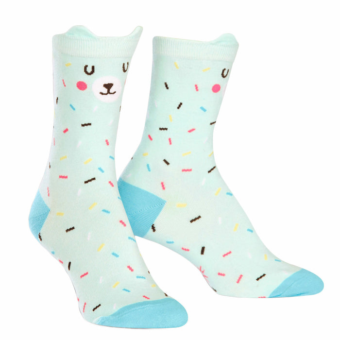 Pair of mint green crew socks with a cute bear face and colorful sprinkles design. Light blue heel and toe. }}