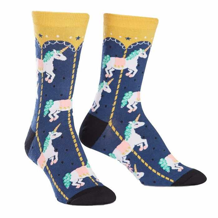 Crew socks in navy blue with a pattern of white unicorns riding a gold carousel. Yellow cuffs and pink, green details. }}