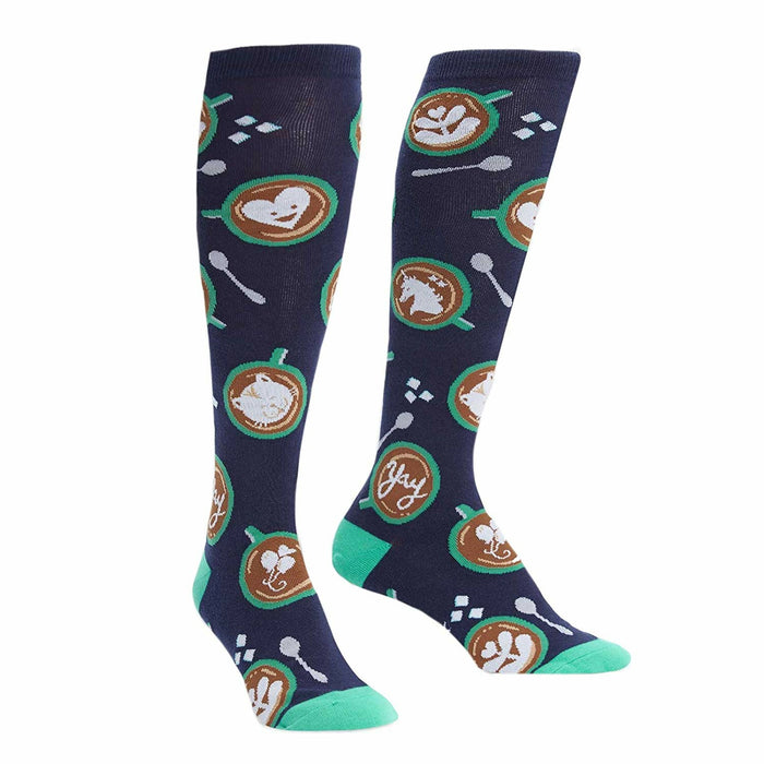 Pair of navy blue knee-high socks with latte art (hearts, horses, cats), teal spoons, and sugar cubes. }}