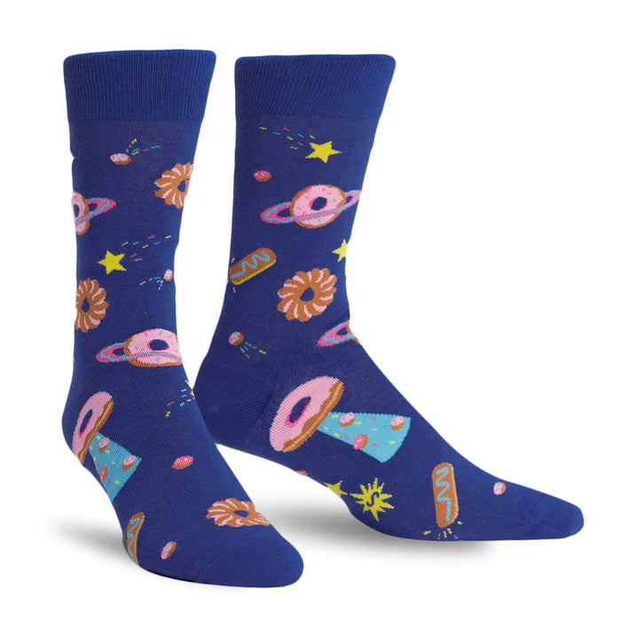 Pair of crew socks. Deep blue background with a pattern of donut-shaped planets, stars, and other space pastries in pink, brown, and light blue. }}