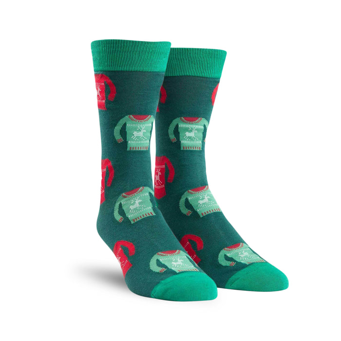 Pair of teal crew socks with a repeating pattern of red and green holiday sweaters featuring reindeer. }}