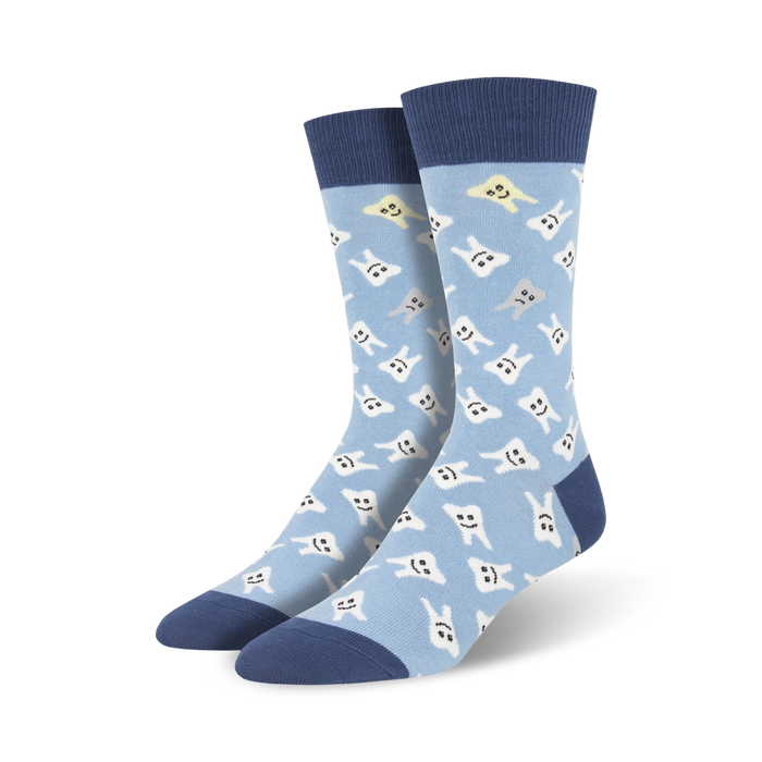 Pair of light blue crew socks with a pattern of happy and slightly unhappy white teeth. Navy blue cuffs. }}