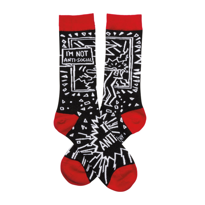 A pair of black crew socks with a red cuff.  The design features a white cartoonish figure, geometric shapes, and the text 'I'm not anti-social'. }}