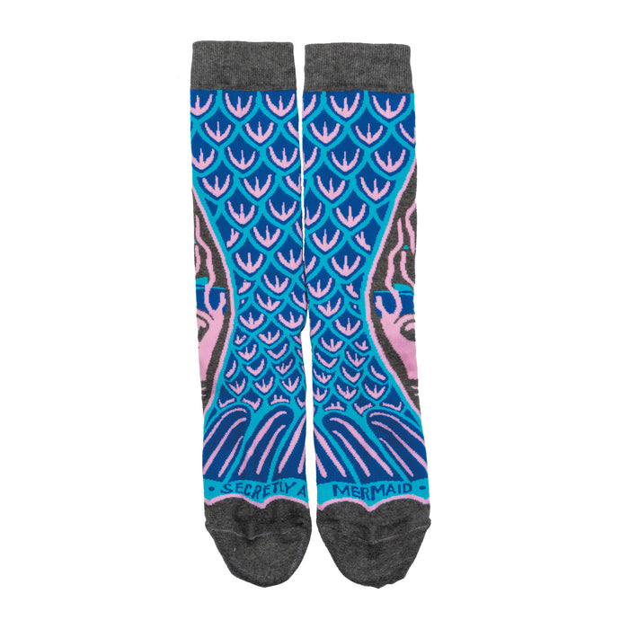 A pair of crew socks with a teal and pink mermaid tail design. The cuffs are grey and the words 'Secretly a Mermaid' are on the bottom. }}