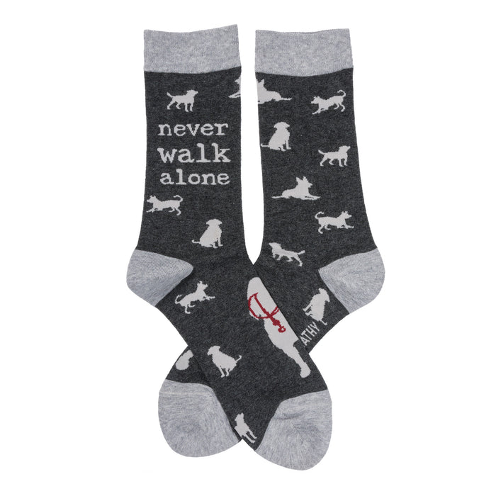 Crew socks, dark gray with light gray cuffs. Feature white dog silhouettes and the text 'Never Walk Alone'. }}