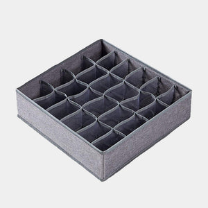 Empty grey fabric sock organizer with 24 compartments, showing the internal structure.