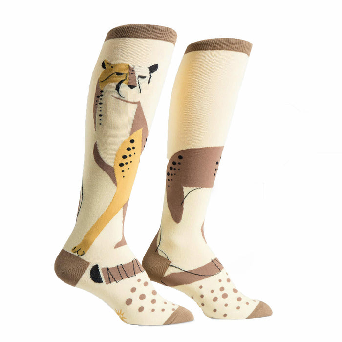 Pair of cream-colored knee-high socks with a stylized cheetah design in brown and gold. Features brown polka dots and a brown cuff. }}