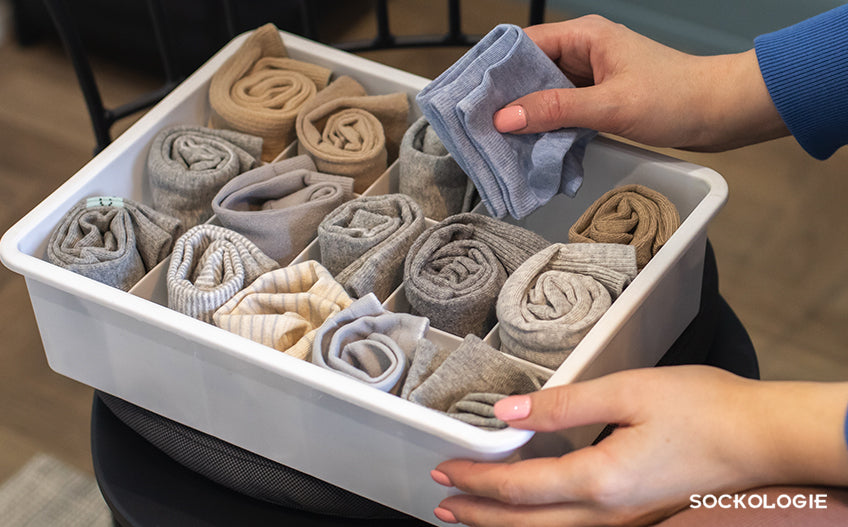 Person putting socks in an organizer