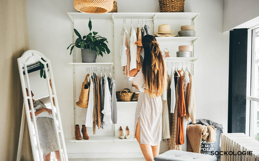 Woman picking clothes from a hanger