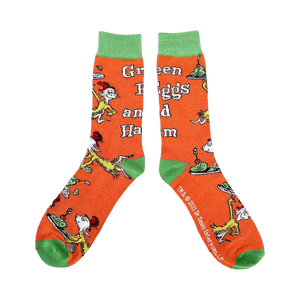 Close-up of a pair of orange crew socks showcasing characters and text from Green Eggs and Ham.