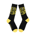 Flatlay product shot of a pair of black Cobra Kai socks with yellow accents showing the full Cobra Kai logo.