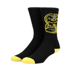 Pair of black crew socks with a yellow Cobra Kai logo. Yellow accents at the heel and toe.