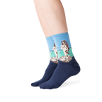 Lifestyle shot showing the socks on a person's legs, against a green background.