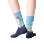 Back view lifestyle shot of a person wearing the socks against a dark grey background.