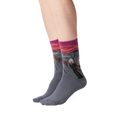 The Scream socks shown on a person's legs against a black background.