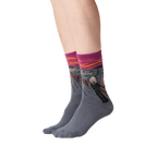 The Scream socks shown on a person's legs against a black background.