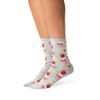 Lifestyle photo showing the socks on a person's legs; they are grey with a school supplies pattern.