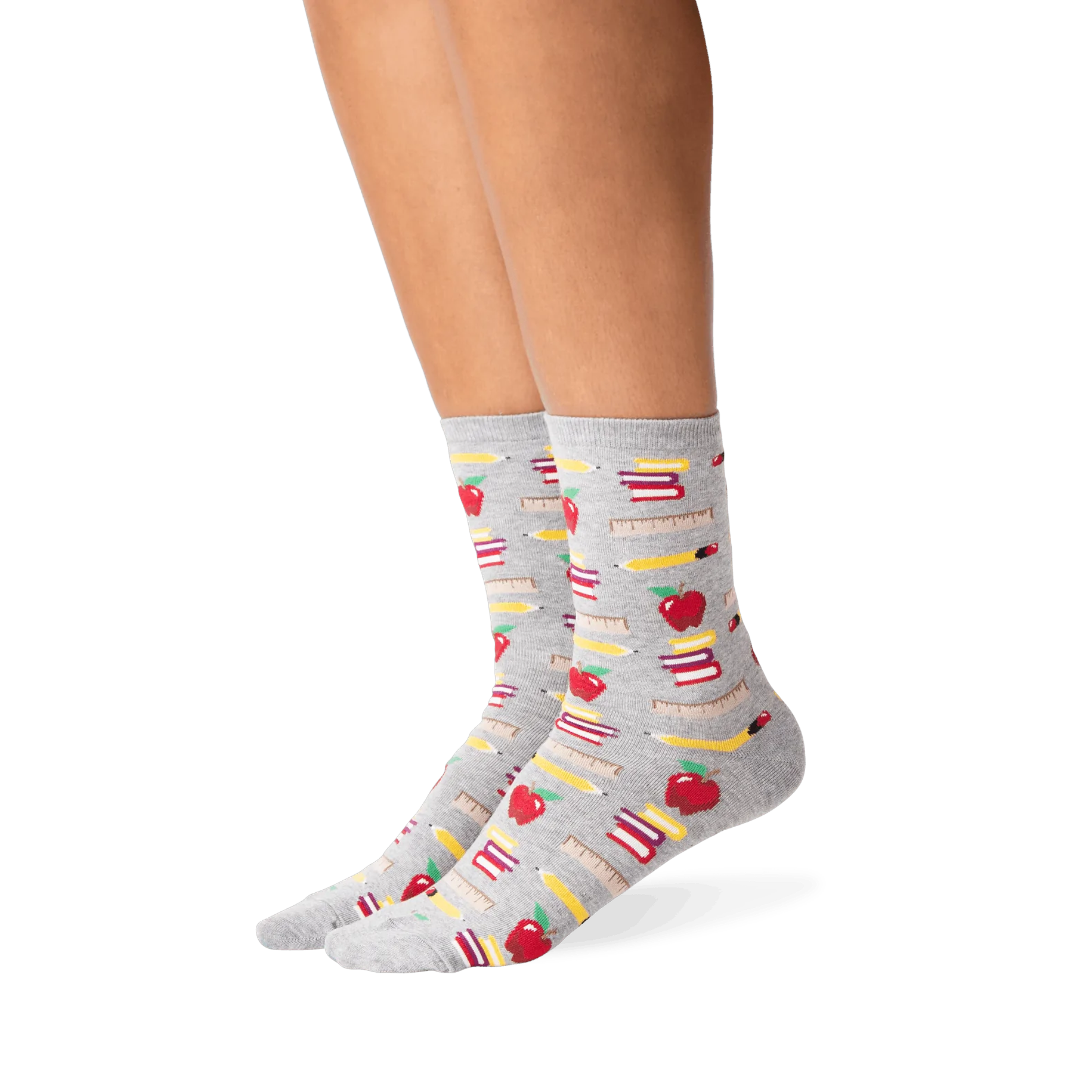 Lifestyle photo showing the socks on a person's legs; they are grey with a school supplies pattern.