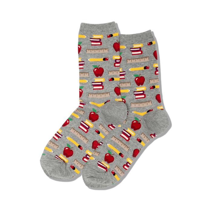 crew-length women's socks with colorful pattern of red apples, yellow pencils, green rulers, and books.  