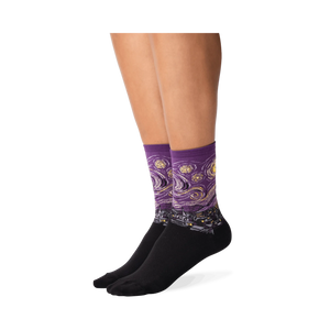 Lifestyle shot: A person's legs wearing a pair of purple Van Gogh's Starry Night socks.