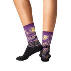 Back view of a person wearing purple Van Gogh's Starry Night socks, showcasing the sock's fit and design.