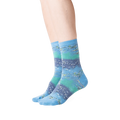 Lifestyle shot showing the Monet's Waterlilies socks on a woman's legs.