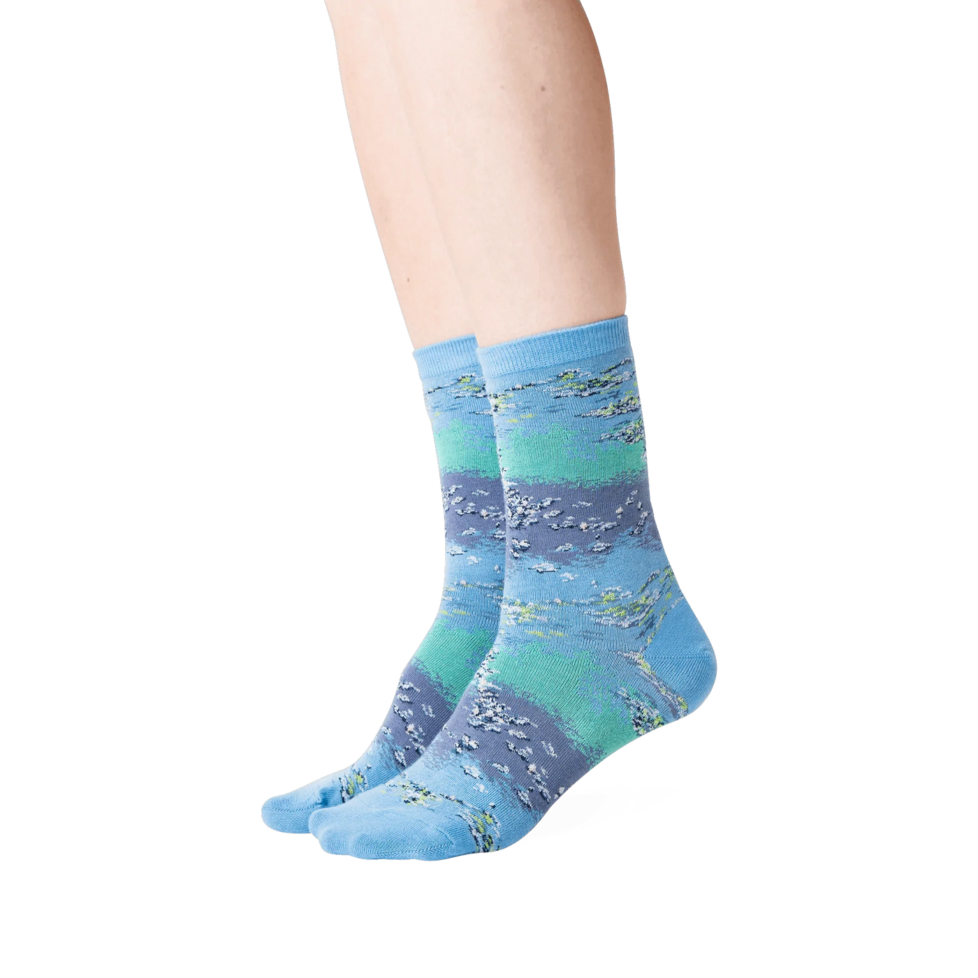 Lifestyle shot showing the Monet's Waterlilies socks on a woman's legs.