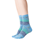 Lifestyle shot showing the Monet's Waterlilies socks on a woman's legs.