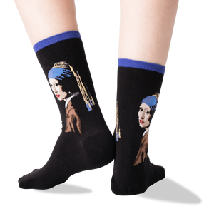 A pair of black socks with a colorful pattern of a painting of a woman with a pearl earring on each sock.