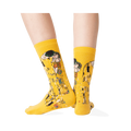 Back view of a person wearing Klimt's The Kiss socks, highlighting the back of the design.