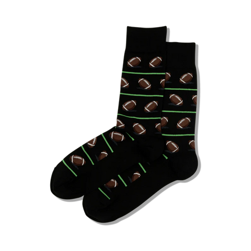 Pair of black crew socks with repeating pattern of brown footballs and lime green stripes.