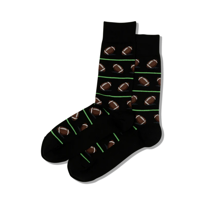black crew length socks with brown footballs with green stripes for men.   