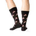 Rear view of the black pizza socks on a model, displaying the pizza pattern on the back of the socks.