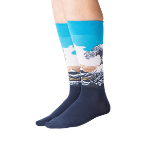 Lifestyle shot of model wearing Hokusai's Great Wave socks, showcasing the fit and design on legs.